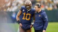 Green Bay Packers head coach Matt LaFleur talks to quarterback Jordan Love (10) during the second half against the Carolina Panthers at Lambeau Field.