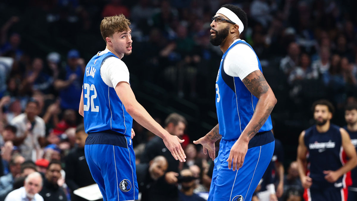 Mavericks forward Cooper Flagg (32) celebrates with Dallas Mavericks forward Anthony Davis (3) during the first quarter against the Washington Wizards at American Airlines Center