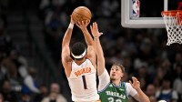 Mavericks forward Cooper Flagg defends Suns' Devin Booker