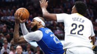 Mavericks forward Daniel Gafford (21) looks to score as New Orleans Pelicans center Derik Queen (22) defends during the second half at American Airlines Center with Mavericks All-Star Anthony Davis and Dereck Lively II in the background