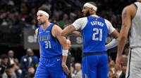 Mavericks guard Klay Thompson (31) and center Daniel Gafford (21) celebrate