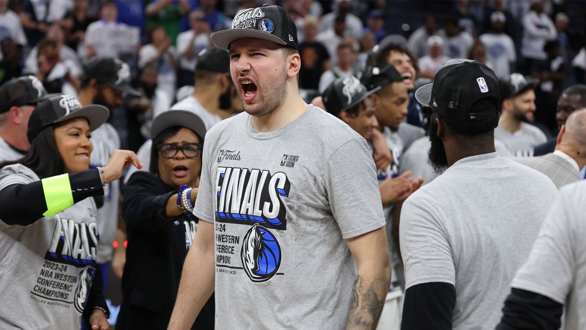 Mavericks guard Luka Doncic (77) celebrates after winning