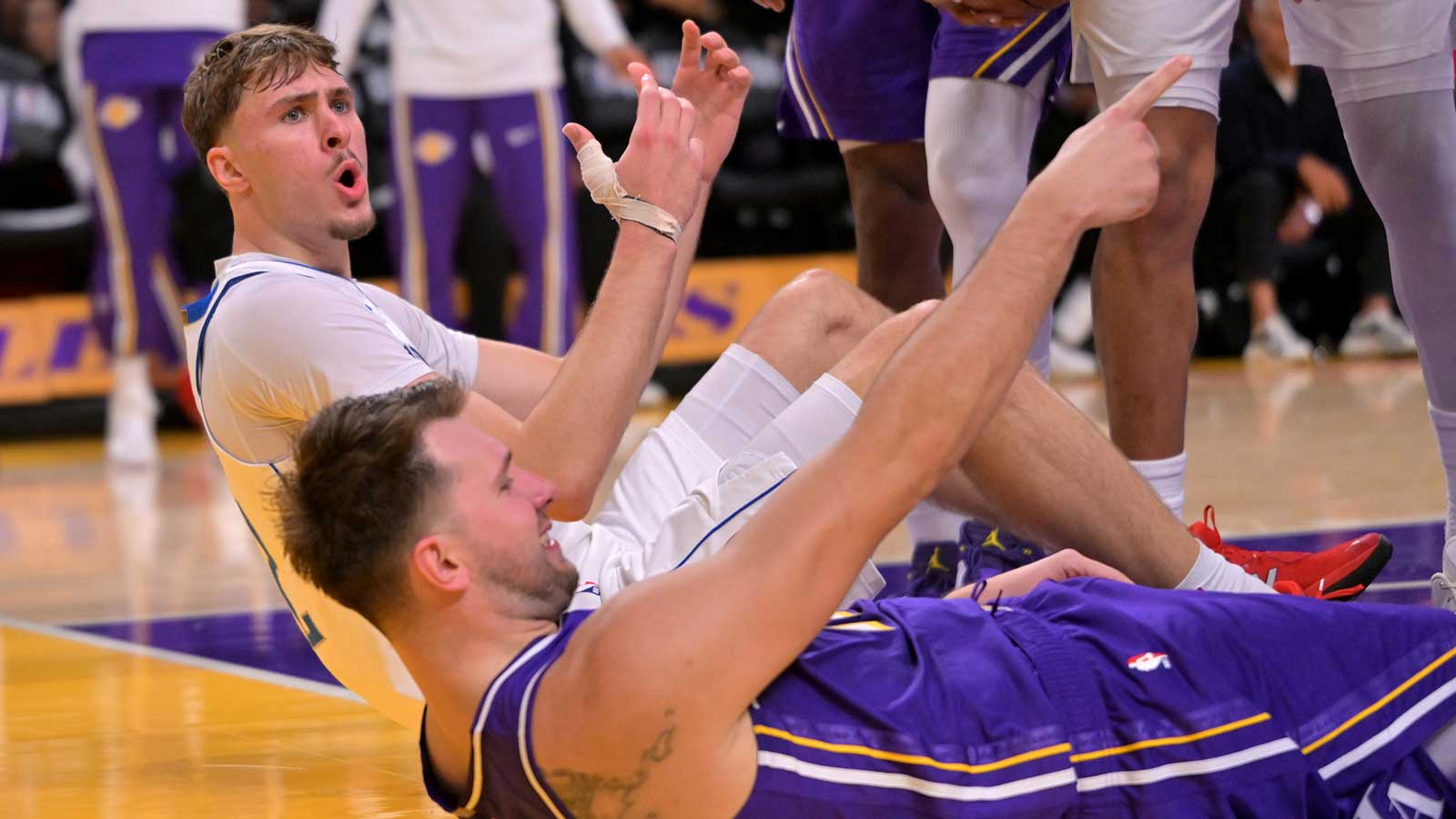 Mavericks forward Cooper Flagg (32) reacts after he was charged with an offensive foul on Los Angeles Lakers guard Luka Doncic (77) in the second half at Crypto.com Arena