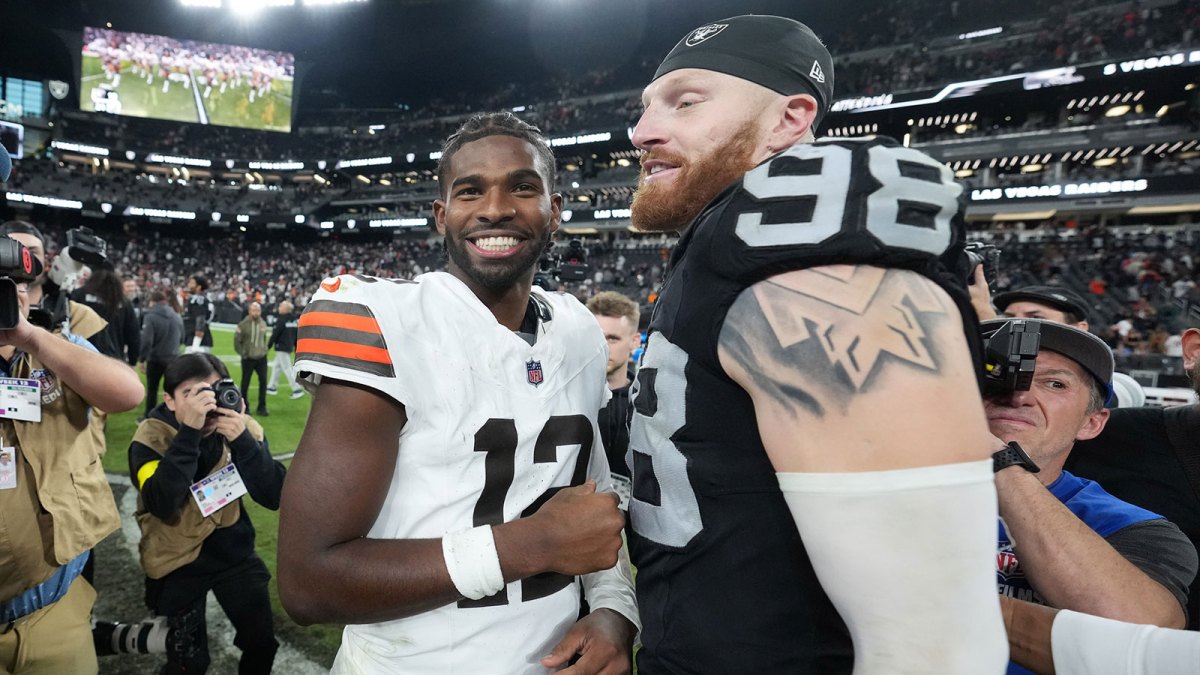 Las Vegas Raiders defensive end Maxx Crosby (98) and Cleveland Browns quarterback Shedeur Sanders (12) embrace after the game at Allegiant Stadium.