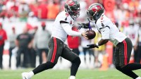 Tampa Bay Buccaneers quarterback Baker Mayfield (6) hands the ball to running back Bucky Irving (7) during the first quarter against the Philadelphia Eagles at Raymond James Stadium.