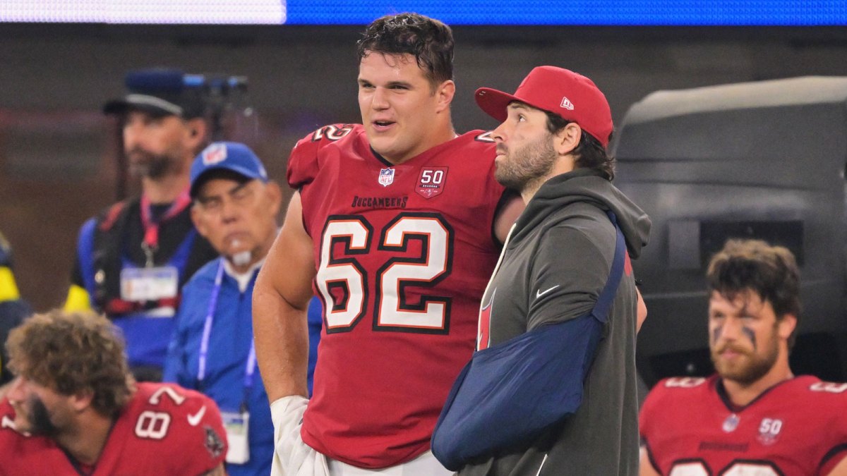 Tampa Bay Buccaneers quarterback Baker Mayfield (6) stands on the sideline with his left arm in a sling and chats with center Graham Barton (62) during the fourth quarter at SoFi Stadium.