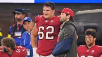 Tampa Bay Buccaneers quarterback Baker Mayfield (6) stands on the sideline with his left arm in a sling and chats with center Graham Barton (62) during the fourth quarter at SoFi Stadium.
