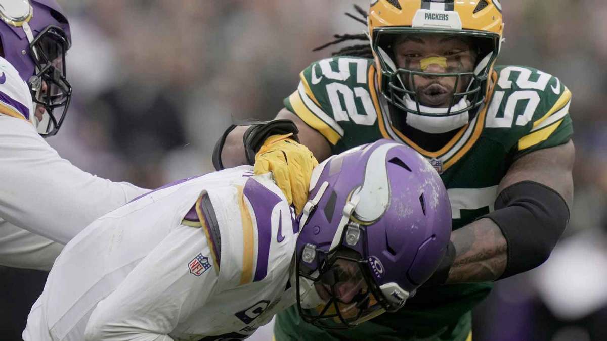 Minnesota Vikings' J.J. McCarthy (9) evades a sack by Green Bay Packers defensive end Rashan Gary (52) during the fourth quarter of their game Sunday, November 23, 2025 at Lambeau Field in Green Bay, Wisconsin. The Green Bay Packers beat the Minnesota Vikings 23-6.
