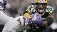 Minnesota Vikings' J.J. McCarthy (9) evades a sack by Green Bay Packers defensive end Rashan Gary (52) during the fourth quarter of their game Sunday, November 23, 2025 at Lambeau Field in Green Bay, Wisconsin. The Green Bay Packers beat the Minnesota Vikings 23-6.