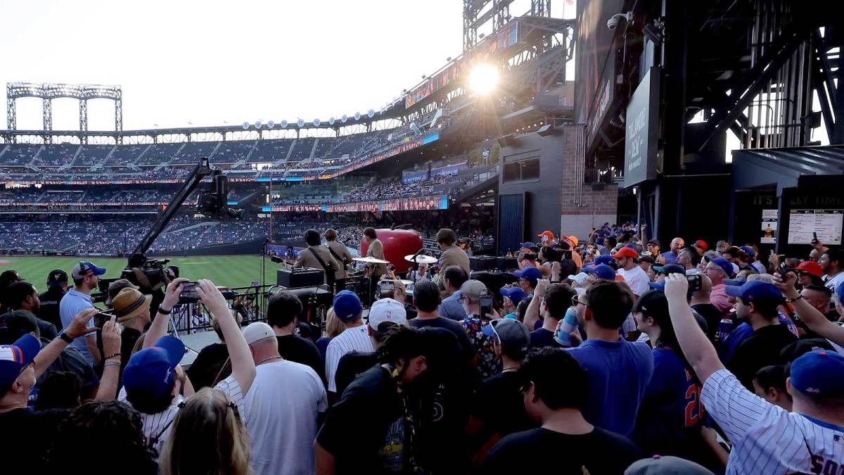 Fans watch and listen as Beatles tribute band 1964 the Tribute performs before a game between the New York Mets and Seattle Mariners at Citi Field.