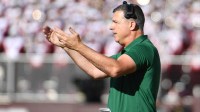 Hurricanes head coach Mario Cristobal signals for his team during the second quarter against the Virginia Tech Hokies at Lane Stadium.