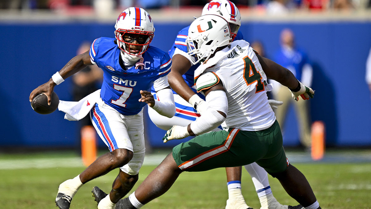SMU Mustangs quarterback Kevin Jennings (7) eludes the rush of Miami Hurricanes defensive lineman Rueben Bain Jr. (4) during the second half at Gerald J. Ford Stadium.