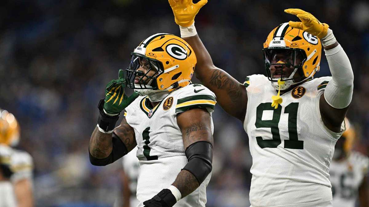Green Bay Packers defensive end Micah Parsons (1) and Green Bay Packers defensive tackle Warren Brinson (91) celebrate after a play against the Detroit Lions during the first quarter at Ford Field.