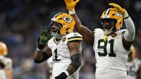 Green Bay Packers defensive end Micah Parsons (1) and Green Bay Packers defensive tackle Warren Brinson (91) celebrate after a play against the Detroit Lions during the first quarter at Ford Field.