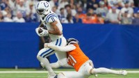 Denver Broncos cornerback Riley Moss (21) tackles Indianapolis Colts wide receiver Michael Pittman Jr. (11) on Sunday, Sept. 14, 2025, during a game at Lucas Oil Stadium in Indianapolis.