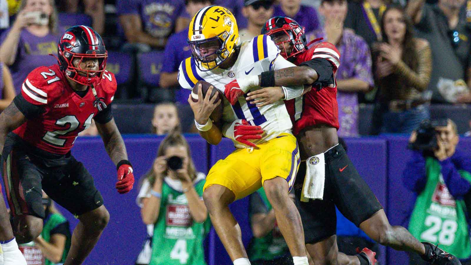 Western Kentucky Hilltoppers defensive back Jaylen Lewis (7) tackles LSU Tigers quarterback Michael van Buren Jr. (11) during the second half at Tiger Stadium. Mandatory Credit: Stephen Lew-Imagn Images