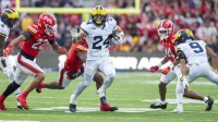 Michigan Wolverines running back Bryson Kuzdzal (24) rushes as Maryland Terrapins defensive back Jalen Huskey (22) defends during the first half at SECU Stadium.