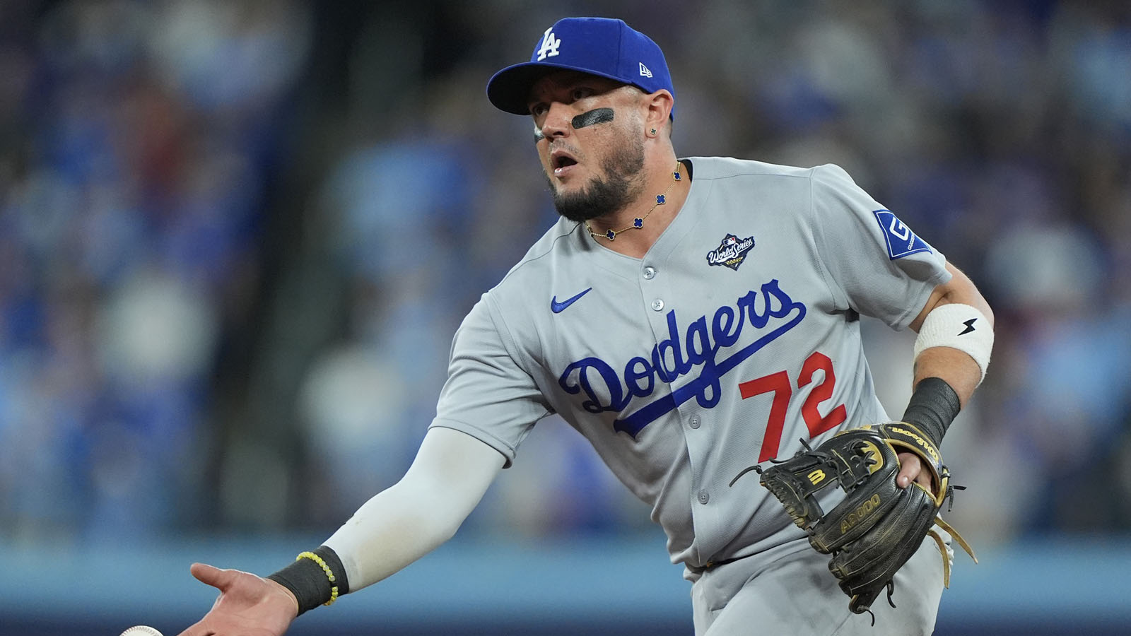 Los Angeles Dodgers second baseman Miguel Rojas (72) throws to first baseman Freddie Freeman (5) for an out against Toronto Blue Jays shortstop Andres Gimenez (0) in the tenth inning during game seven of the 2025 MLB World Series at Rogers Centre.