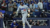 Los Angeles Dodgers second baseman Miguel Rojas (72) celebrates as he runs the bases after hitting a home run against the Toronto Blue Jays in the ninth inning during game seven of the 2025 MLB World Series at Rogers Centre.