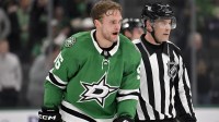 Dallas Stars right wing Mikko Rantanen (96) is led off the ice after he receives a game misconduct penalty for boarding on New York Islanders defenseman Alexander Romanov (not pictured) during the third period at the American Airlines Center.