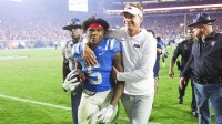 Mississippi Rebels head coach Lane Kiffin embraces running back Kewan Lacy (5) after defeating the Florida Gators at Vaught-Hemingway Stadium.