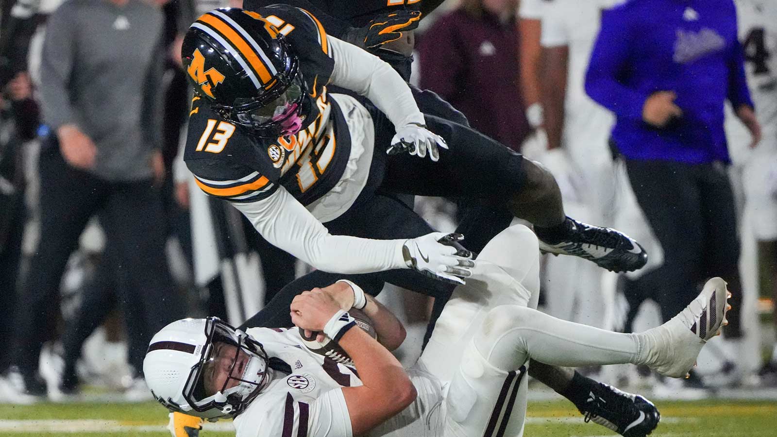 Mississippi State Bulldogs quarterback Blake Shapen (2) runs the ball as Missouri Tigers safety Daylan Carnell (13) attempts the tackle during the first half of the game at Faurot Field at Memorial Stadium.