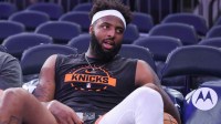 New York Knicks center Mitchell Robinson (23) sits courtside during pregame warmups prior to the game against the Brooklyn Nets at Madison Square Garden.