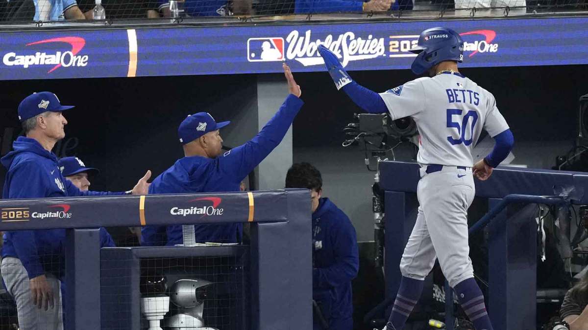 Los Angeles Dodgers shortstop Mookie Betts (50) celebrates with the dugout after scoring against the Toronto Blue Jays in the sixth inning during game seven of the 2025 MLB World Series at Rogers Centre.