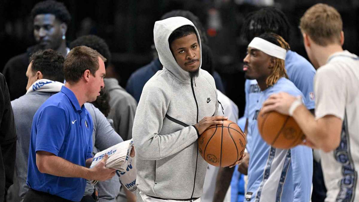 Memphis Grizzlies guard Ja Morant (center) looks on from the team bench during the first quarter against the Dallas Mavericks at the American Airlines Center.