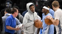 Memphis Grizzlies guard Ja Morant (center) looks on from the team bench during the first quarter against the Dallas Mavericks at the American Airlines Center.