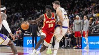 Atlanta Hawks forward Mouhamed Gueye (18) dribbles against Los Angeles Lakers guard Luka Doncic (77) during the second half at State Farm Arena.