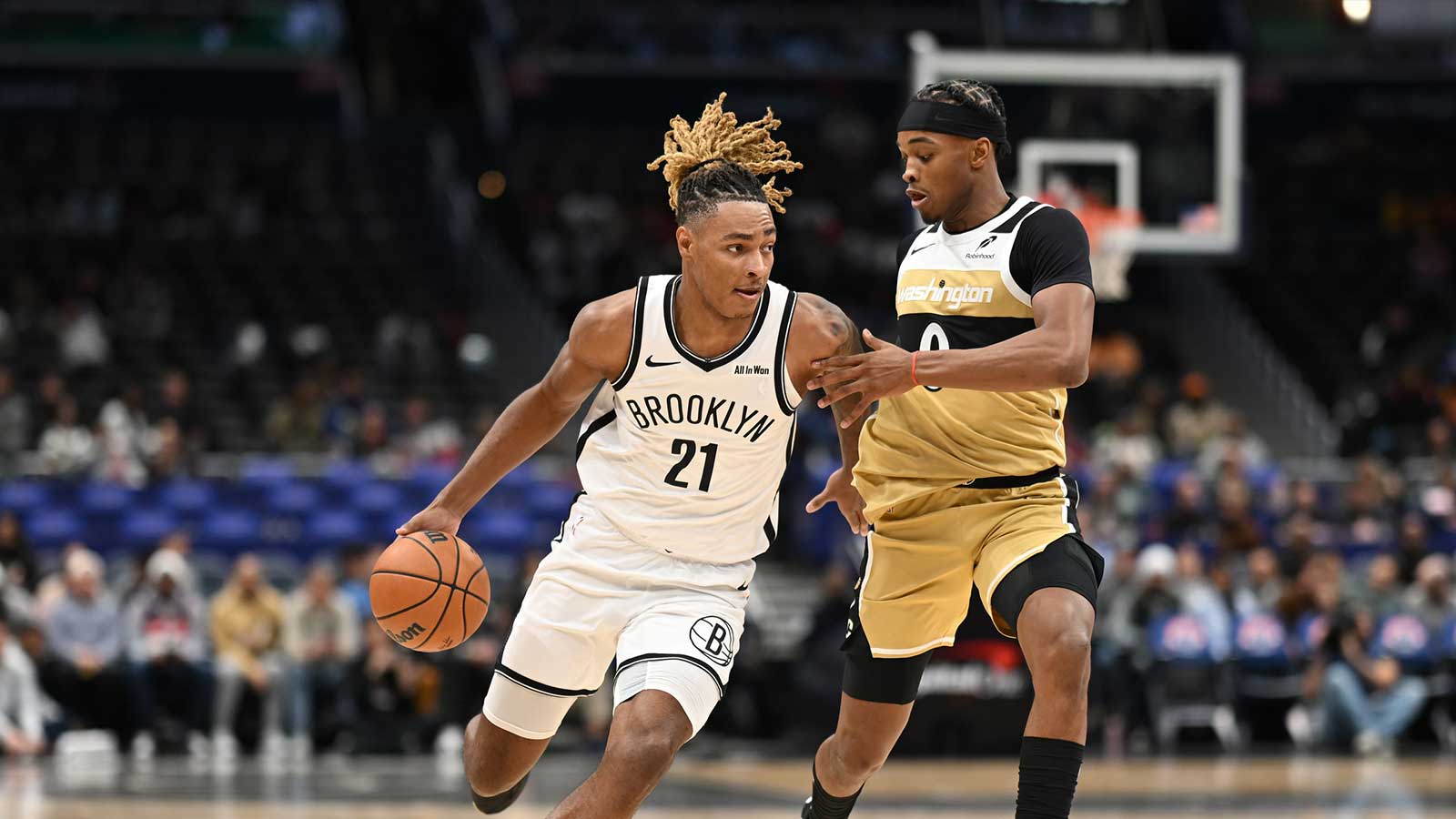 Brooklyn Nets forward Noah Clowney (21) dribbles the ball past Washington Wizards guard Bilal Coulibaly (0) during the first quarter at Capital One Arena.