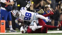 Arizona Cardinals cornerback Will Johnson (0) tackles Dallas Cowboys wide receiver CeeDee Lamb (88) in the second half at AT&T Stadium.