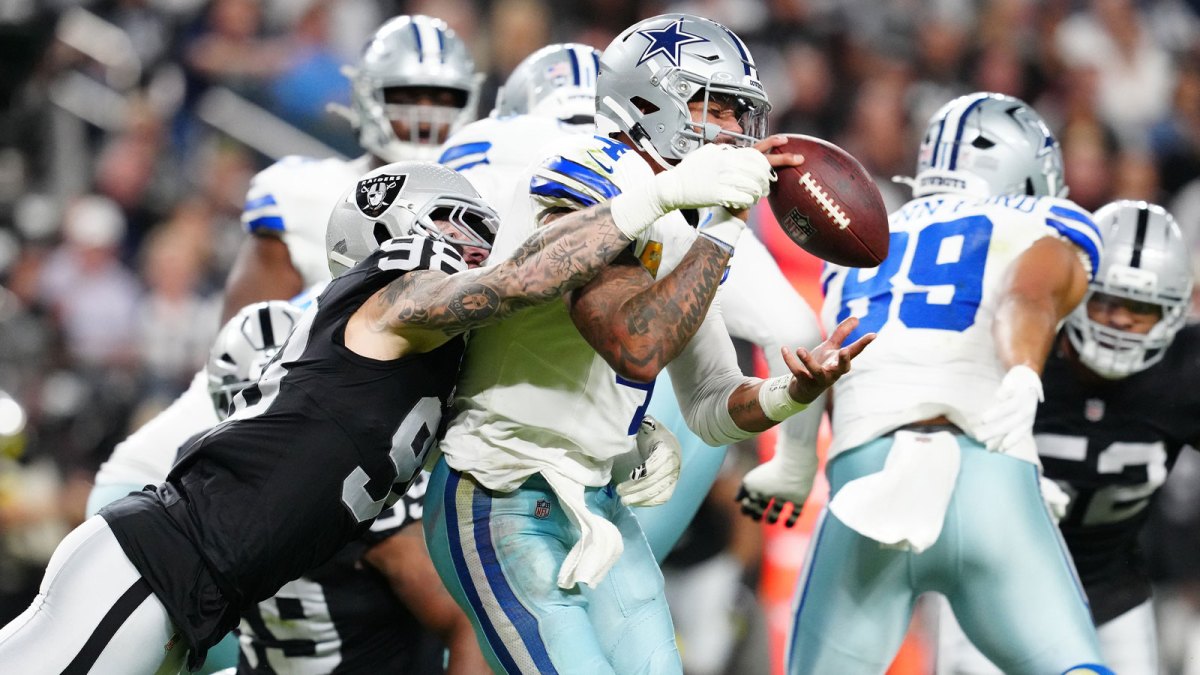 Las Vegas Raiders defensive end Maxx Crosby (98) forces a fumble by Dallas Cowboys quarterback Dak Prescott (4) during the first half at Allegiant Stadium.