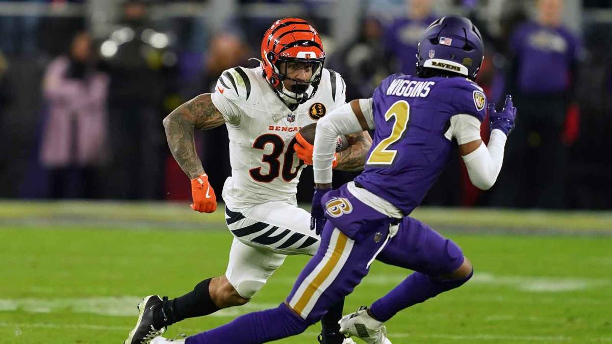 Cincinnati Bengals running back Chase Brown (30) rushes the ball against Baltimore Ravens cornerback Nate Wiggins (2) during the first half at M&T Bank Stadium. Mandatory Credit: Mitch Stringer-Imagn Images