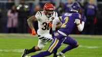 Cincinnati Bengals running back Chase Brown (30) rushes the ball against Baltimore Ravens cornerback Nate Wiggins (2) during the first half at M&T Bank Stadium. Mandatory Credit: Mitch Stringer-Imagn Images