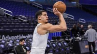 Nets forward Michael Porter Jr. (17) warms up before the game against the Orlando Magic at Kia Center with Warriors' Jonathan Kuminga in the background