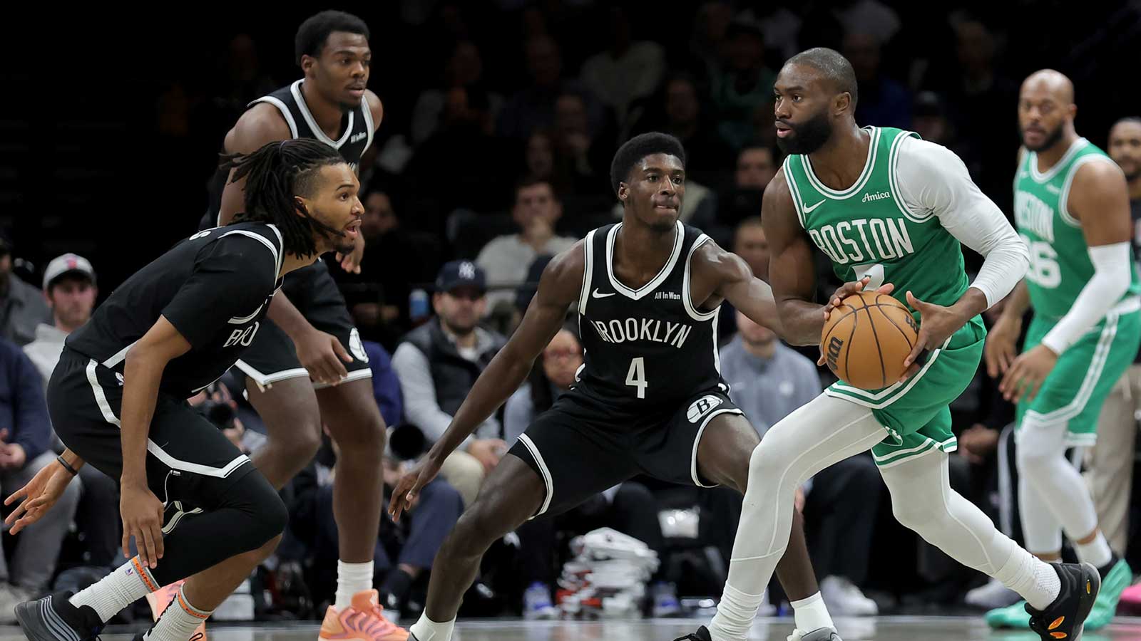 Boston Celtics guard Jaylen Brown (7) looks to pass the ball against Brooklyn Nets forward Ziaire Williams (1) and center Day'Ron Sharpe (20) and guard Drake Powell (4) during the third quarter at Barclays Center.
