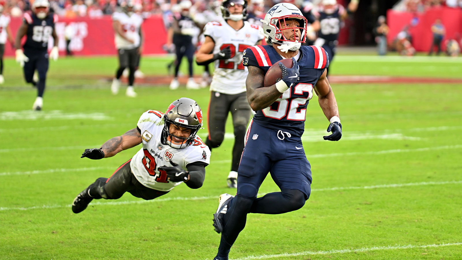New England Patriots running back Treveyon Henderson (32) runs for a touchdown