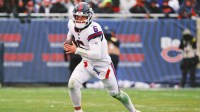 New York Giants quarterback Jaxson Dart (6) rushes the ball against the Chicago Bears during the second half at Soldier Field.