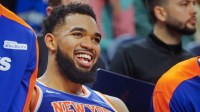 New York Knicks forward Karl-Anthony Towns (32) smiles as he rests on the bench in the fourth quarter of the game with the Minnesota Timberwolves at Target Center.