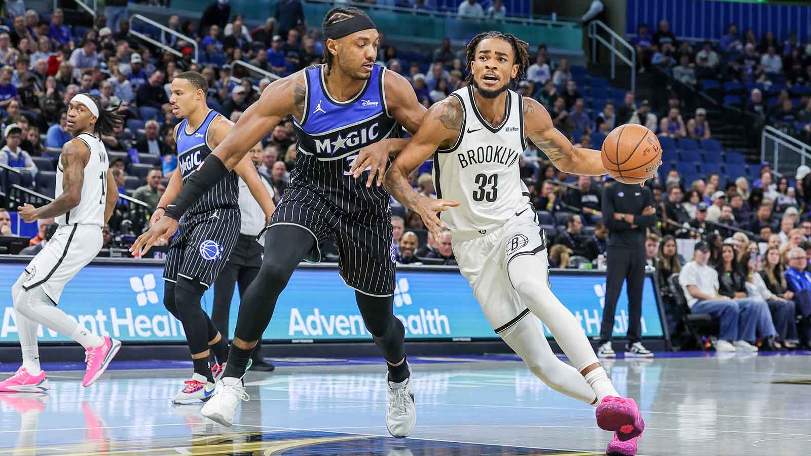 Brooklyn Nets center Nic Claxton (33) drives to the basket around Orlando Magic center Wendell Carter Jr. (34) during the first quarter at Kia Center.