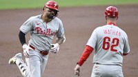 Philadelphia Phillies right fielder Nick Castellanos (8) is congratulated by Dusty Wathan (62) after hitting a solo home run during the second inning against the San Diego Padres at Petco Park.