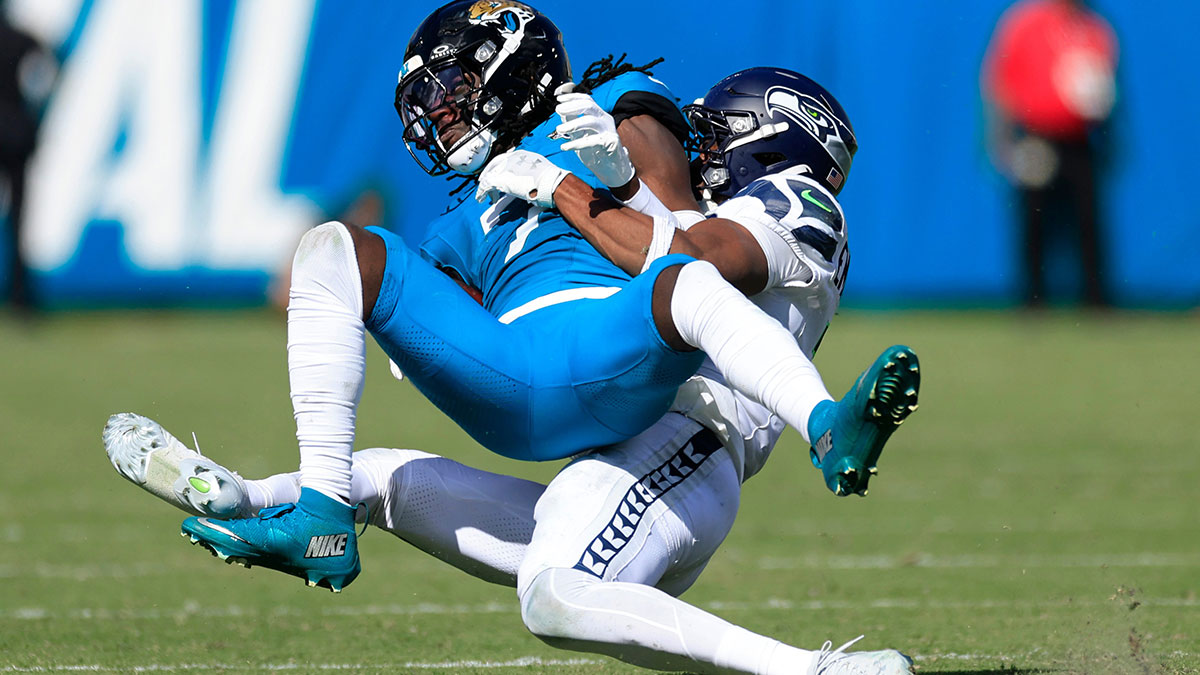 Caption:Jacksonville Jaguars wide receiver Brian Thomas Jr. (7) is tackled by Seattle Seahawks safety Nick Emmanwori (3) during the fourth quarter of an NFL football matchup, Sunday, Oct. 12, 2025, at EverBank Stadium in Jacksonville, Fla. The Seahawks defeated the Jaguars 20-12.