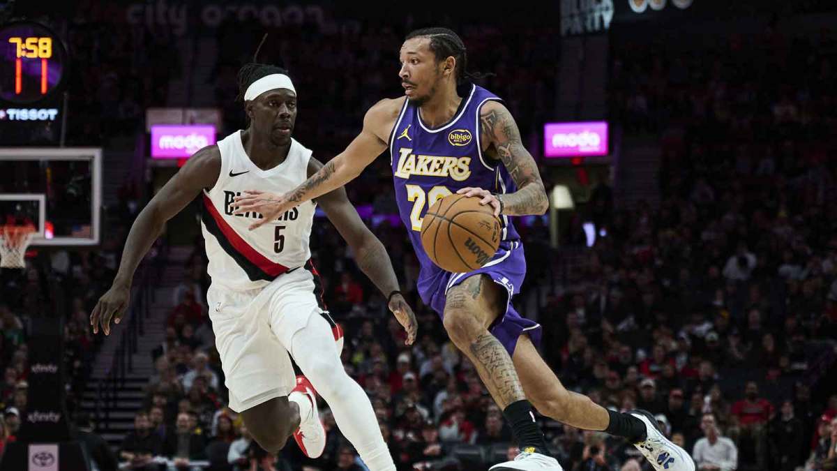 Los Angeles Lakers guard Nick Smith Jr. (20) drives to the basket during the second half against Portland Trail Blazers guard Jrue Holiday (5) at Moda Center.