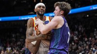 Atlanta Hawks guard Nickeil Alexander-Walker (7) fights for the ball with Charlotte Hornets guard Kon Knueppel (7) during the second half at State Farm Arena.