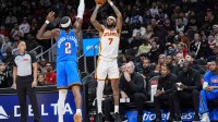 Atlanta Hawks guard Nickeil Alexander-Walker (7) shoots over Oklahoma City Thunder guard Shai Gilgeous-Alexander (2) during the first half at State Farm Arena.