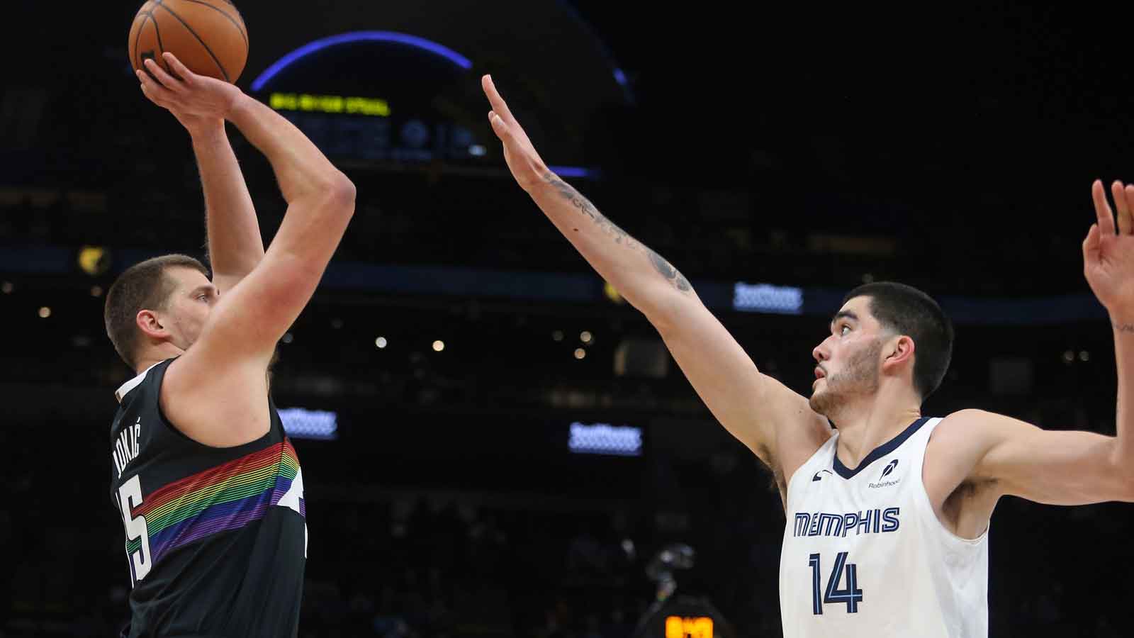 Denver Nuggets center Nikola Jokic (15) shoots as Memphis Grizzlies center Zach Edey (14) defends during the first quarter at FedExForum.