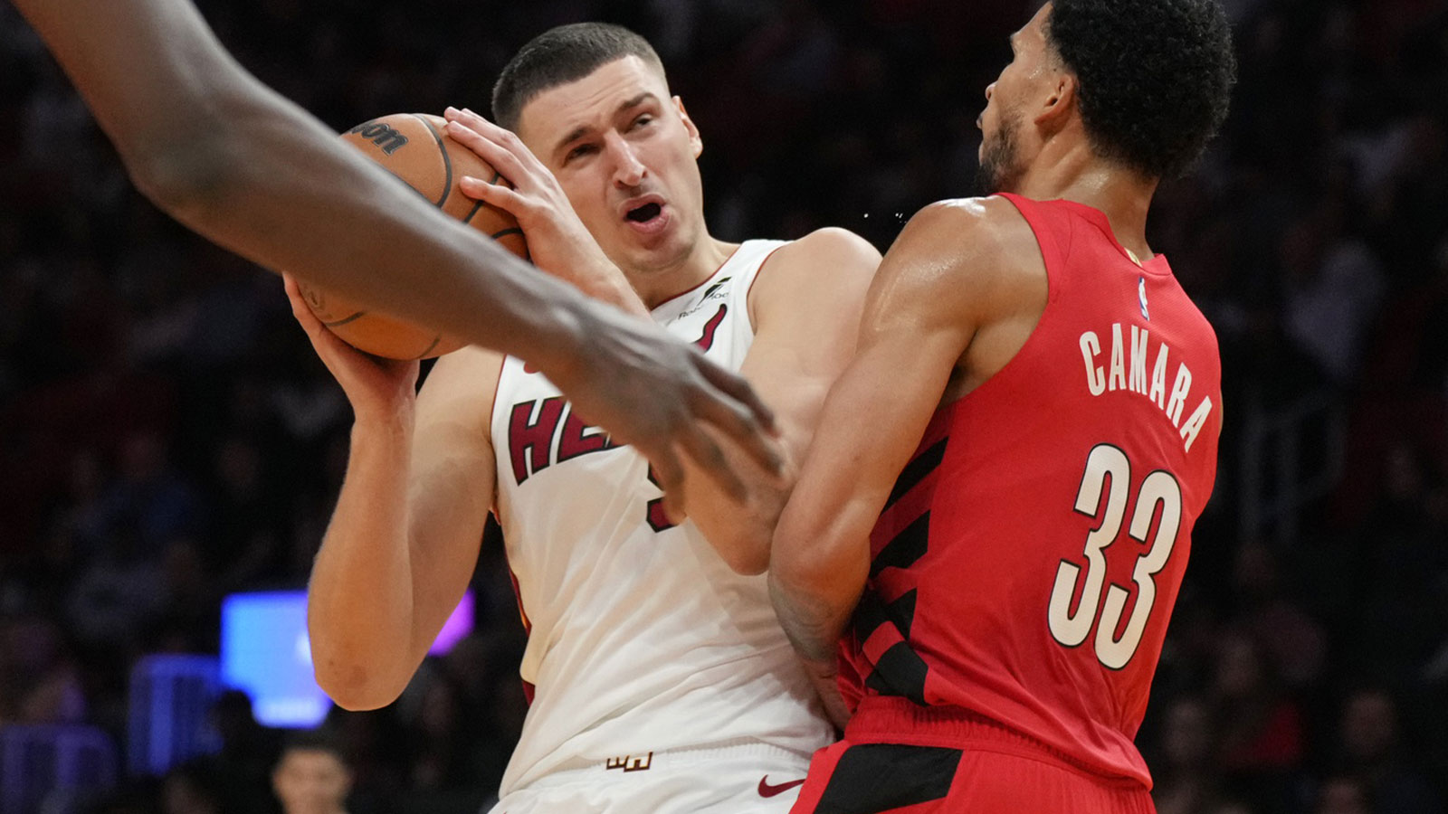 Miami Heat forward Nikola Jovic (5) gets fouled by Portland Trail Blazers forward Toumani Camara (33) in the first quarter at Kaseya Center.