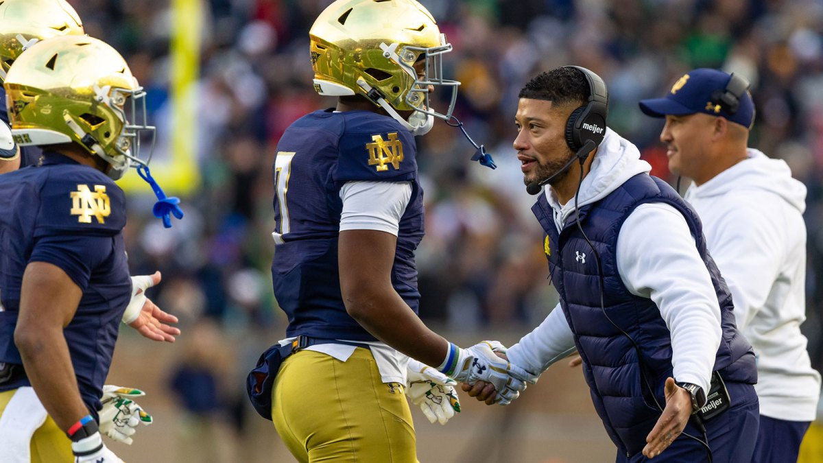 Notre Dame Fighting Irish head coach Marcus Freeman celebrates with player after a touchdown against the Syracuse Orange during the first half at Notre Dame Stadium.
